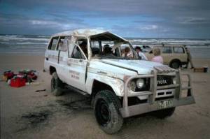 Damaged 4WD on the beach.