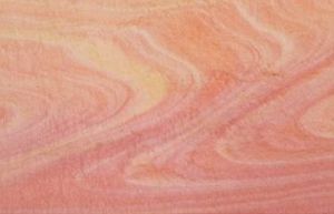 Multi-coloured sand swirls.