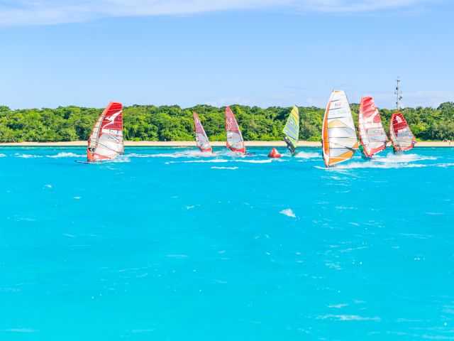 Windsurfers enjoy the turquoise waters off Green Island.