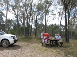 Image of a family at a picnic table where you can stop for a picnic when exploring the park.