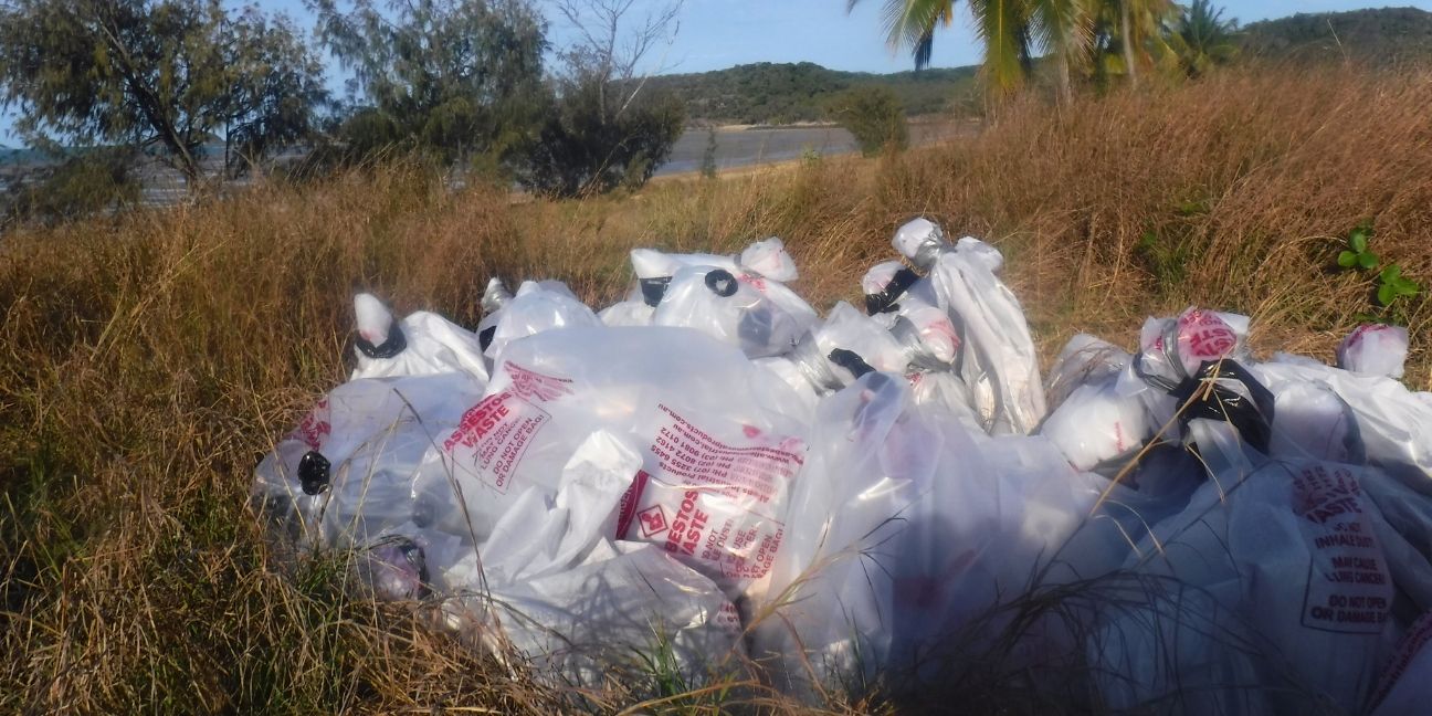 White bags of asbestos ready for removal.
