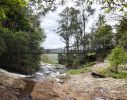 Photo of a view of Purling Brook creek at the top of the creek looking north, with a suspension bridge spanning the creek superimposed