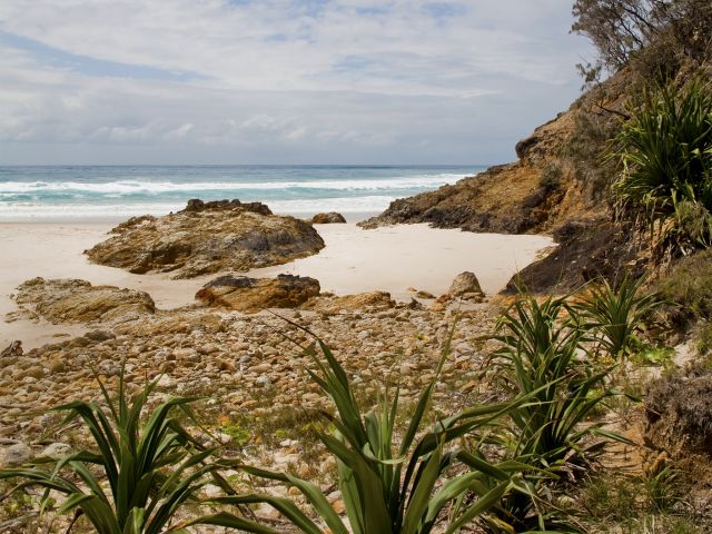 Honeymoon Bay is surrounded by a rocky headland.