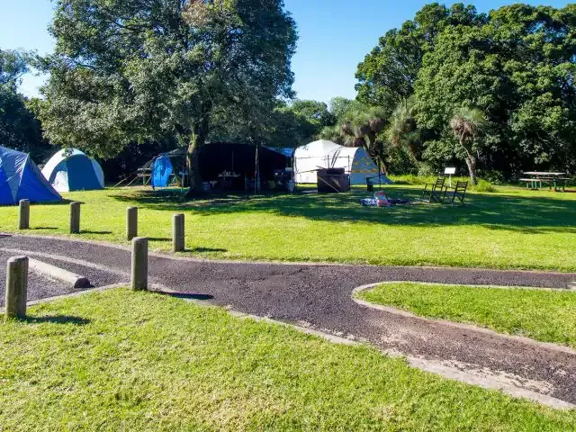 Grassed campground with tents