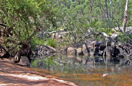 A small sandy beach allows access to Kauyoo Pool.