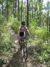 Image of an adult riding on one of many shared trails available for cyclists and horseriders.