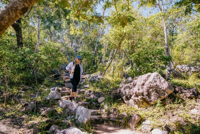 A natural stone walking track leads to the top of the headland.