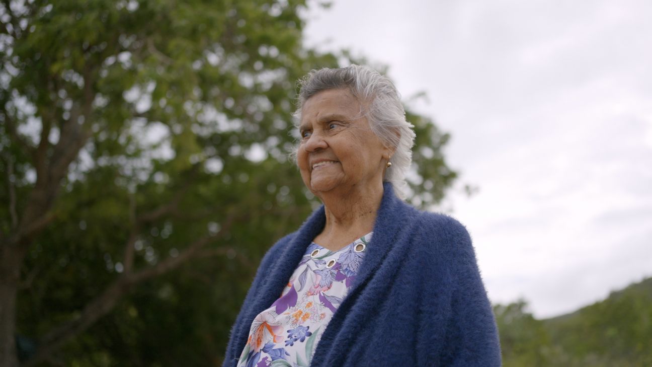 Wulgurukaba female Elder with large tree in background. 