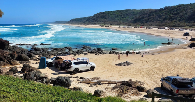 Beachgoers enjoying recreational activities at the beach.