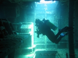 A diver explores the operations room inside the wreck.