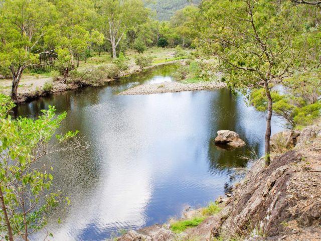 The scenic Permanent Waterhole is a cool retreat from the surrounding dry mountain ranges.