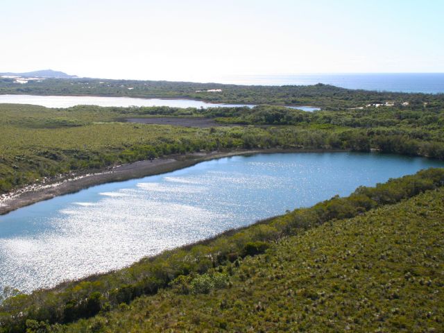 Aerial view of Honeyeater Lake with Blue Lagoon in the background.