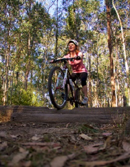 Photo of a woman riding along one of the designated mountain-bike or shared trails.