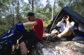 Image of campers under the forest canopy at one of three walkers' camps.