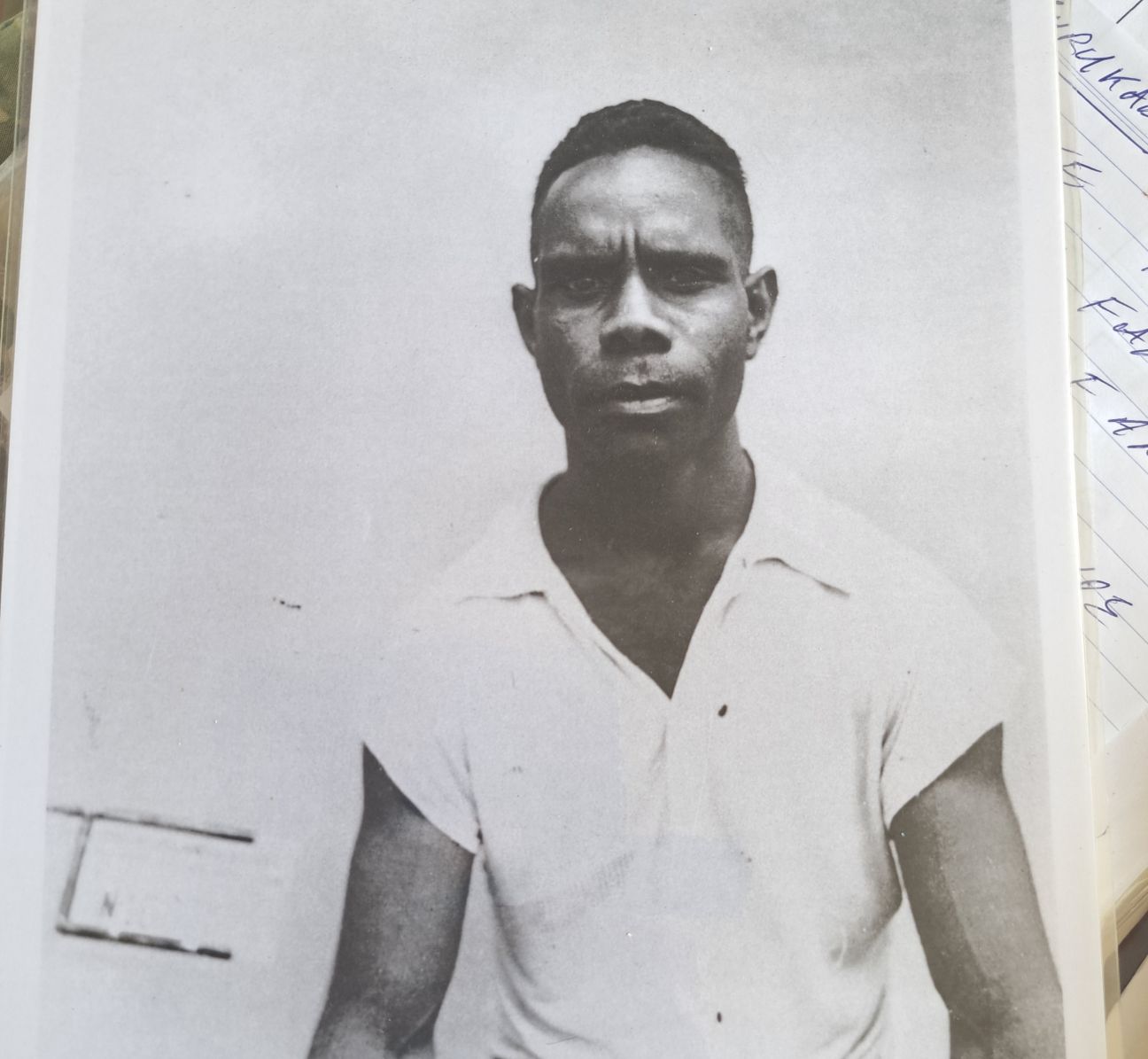Old photograph of Wulgurukaba man looking directly at camera wearing a white shirt. 