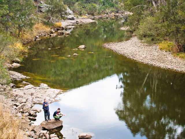 The scenic Permanent Waterhole is a cool retreat from the surrounding dry mountain ranges.