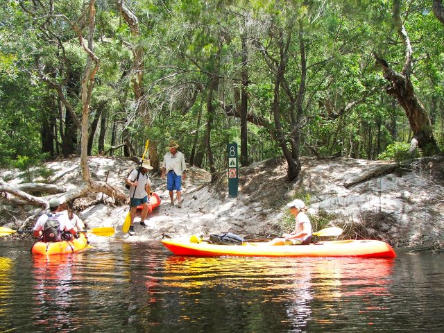 Land your canoe at the small sandy beach and carry it up the bank to your campsite.