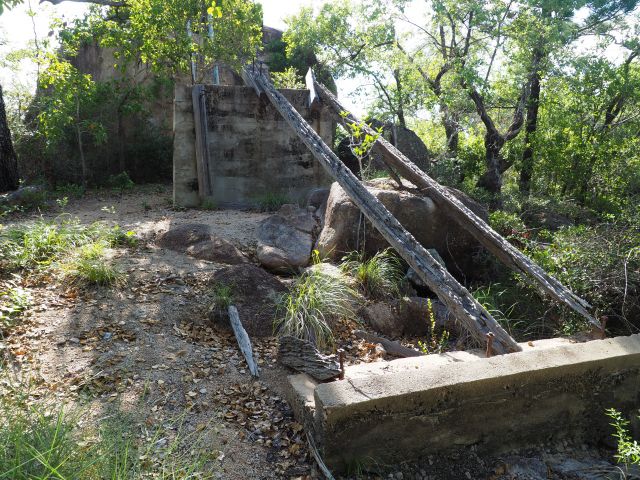 Deteriorated wooden beams and remnants of concrete brick walls, making up the WWII Searchlight Tower structure.