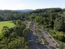 Photo of an aerial view of The Settlement picnic area with a carpark design superimposed on the grassy area