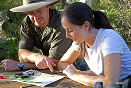 Photo of two people studying a map.