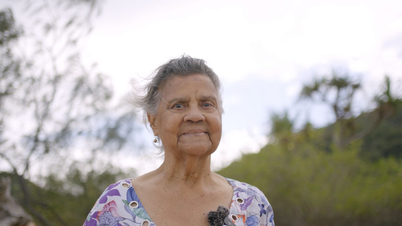 Wulgurukaba female Elder with bush and sky in background. 