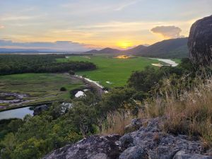 Photo of a stunning sunset across the Town Common wetlands from Tegoora Rock, Many Peaks trail.