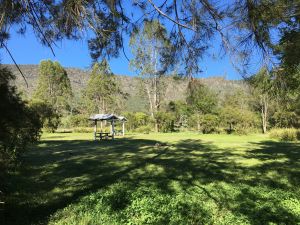 The camping area is situated in a narrow valley surrounded by steep ridges. 