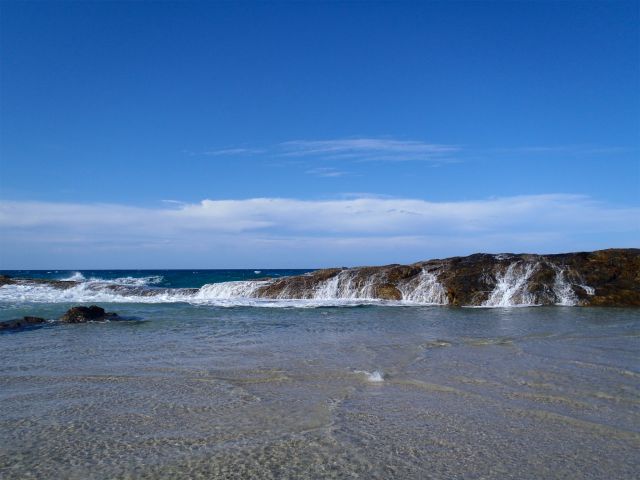 Waves wash over rocks at North Point Champagne Pools on the Northern Island discovery drive.