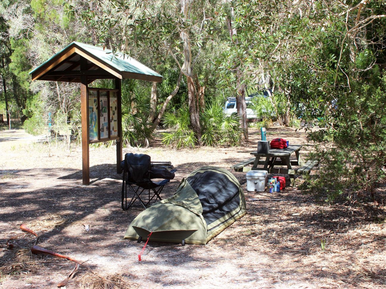 Photo of a swag camp next to an information shelter