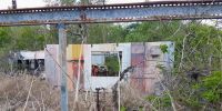 Metal walls and frame of an abandoned shack.