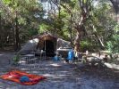 Photo of shaded beach-side tent site