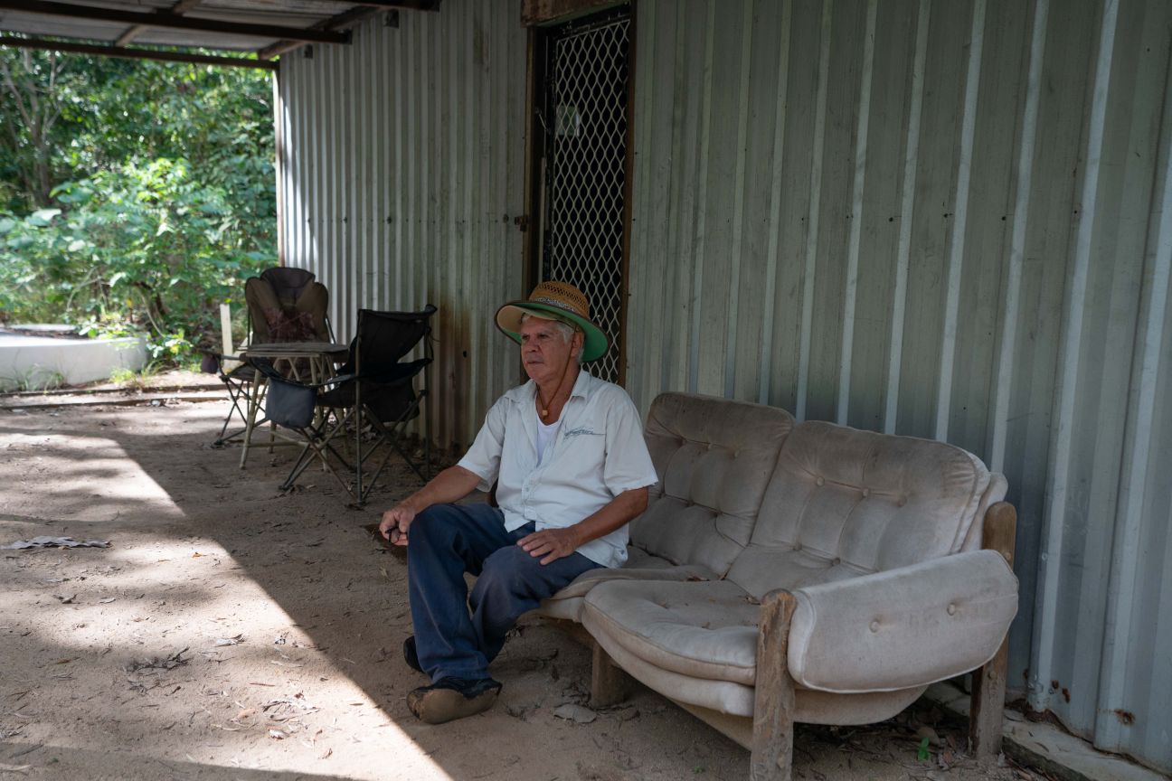 Wulgurukaba male Edler sitting on a lounge under cover of a tin shed. 