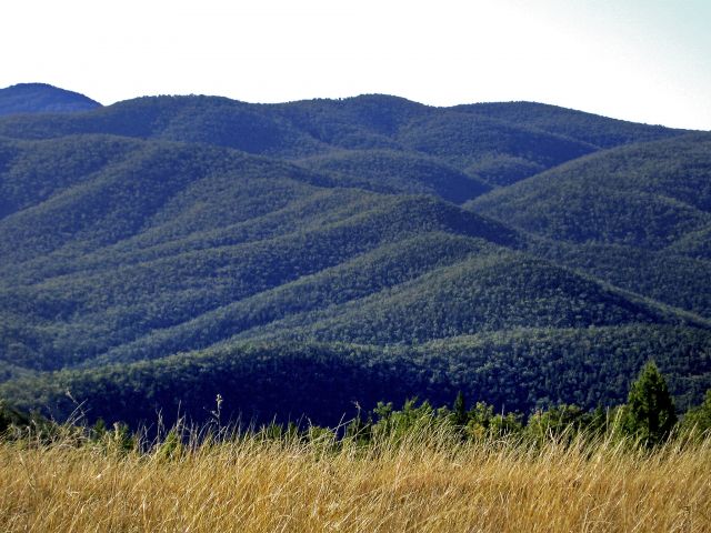 Burrows Waterhole camping area is surrounded by rugged mountain ranges.